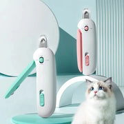 Pet grooming clippers in white with pink and green accents displayed with a fluffy blue-eyed cat