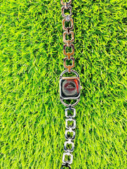 Back view of Lazyna silver women's watch with stainless steel linked bracelet on green grass