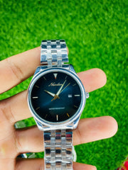 Close-up of hands holding a silver Nuodun waterproof quartz watch with black dial and date display on green grass background