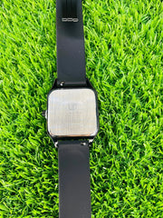 Universe Point black square wristwatch with stainless steel back and black silicone strap on green grass